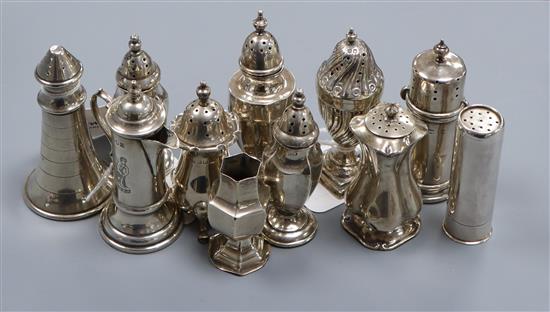 Eleven Victorian and later silver or white metal peppers, including lighthouse, cartridge, wrythen, baluster and tankard examples.